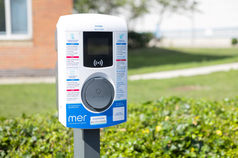 Single EV charging unit by grass