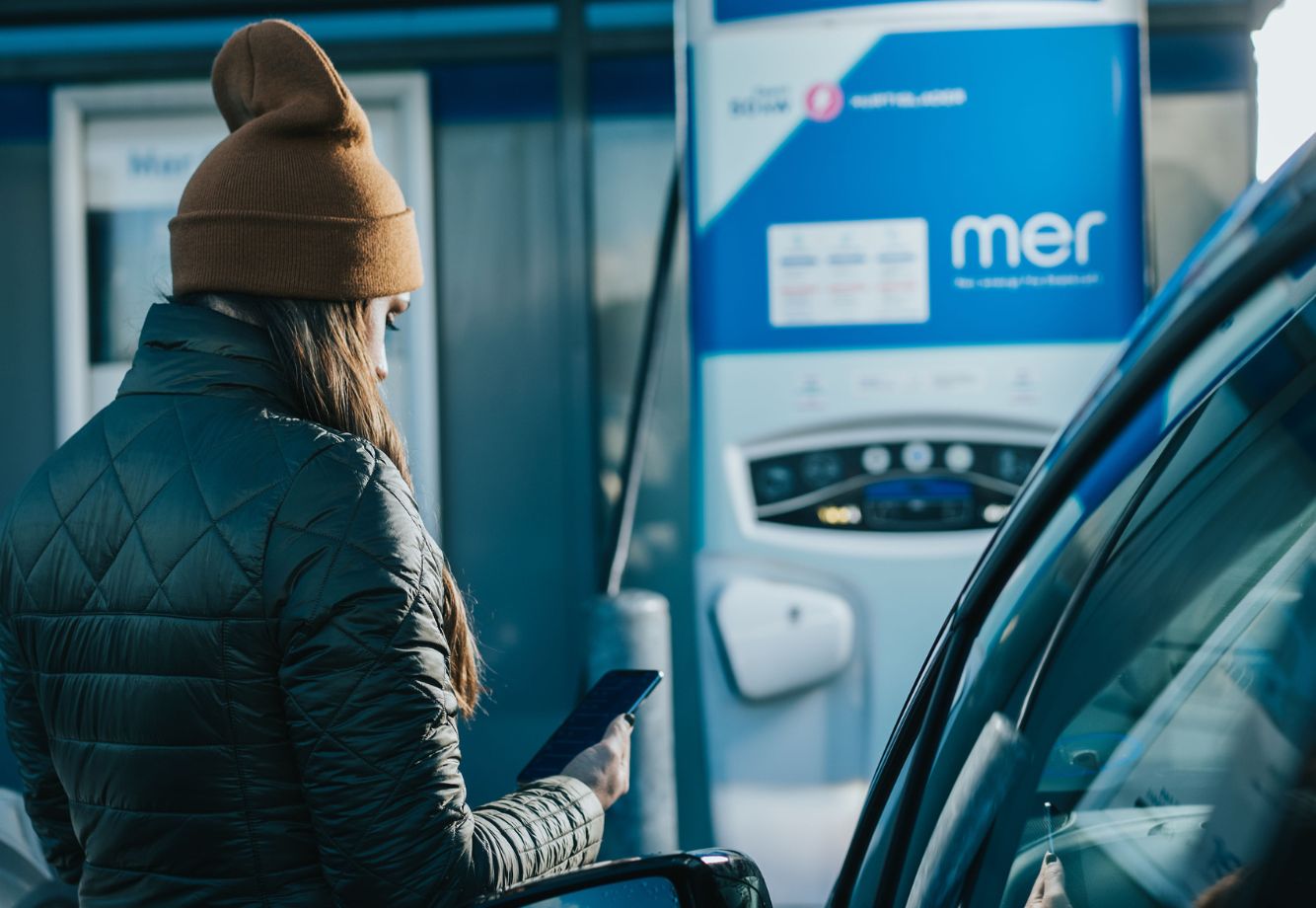 Girl Charging at Mer Public Charger Stations for EV