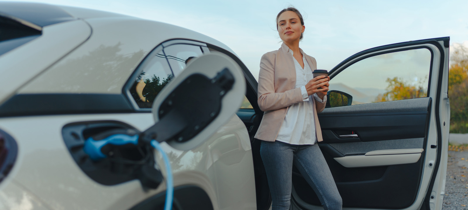 Business Woman Charging Electric Vehicle (EV) - Business EV Charger