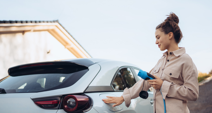 Woman holding electric car charging cable
