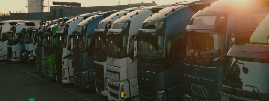 Photo of electric long haul trucks parked in a row