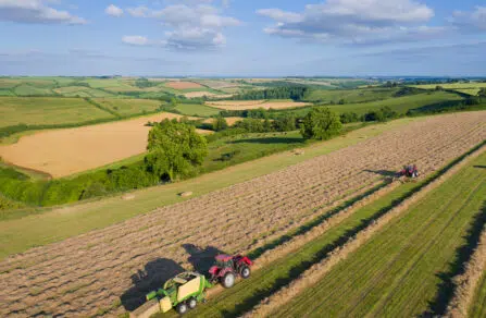 Tractor with trailer going through a field